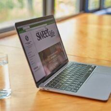 a laptop computer sitting on top of a wooden table