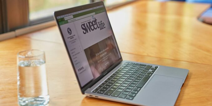 a laptop computer sitting on top of a wooden table