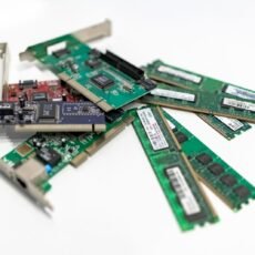 A detailed close-up of computer RAM sticks and PCI cards arranged on a white surface for tech illustration.