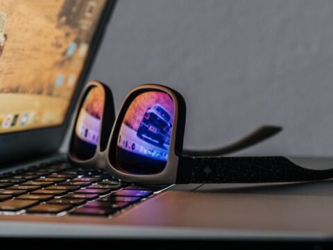 black smartphone on black laptop computer