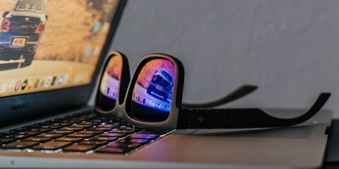 black smartphone on black laptop computer